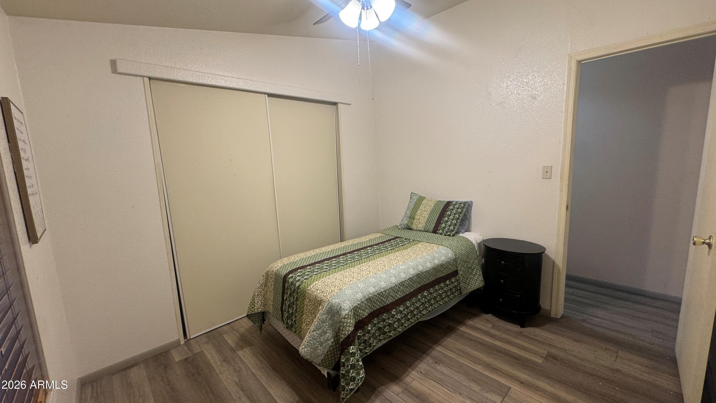 3700 South Tomahawk Road, Unit 95 Apache Junction, AZ 85119 - Photo 16 of 31 a bedroom with a bed and a chandelier