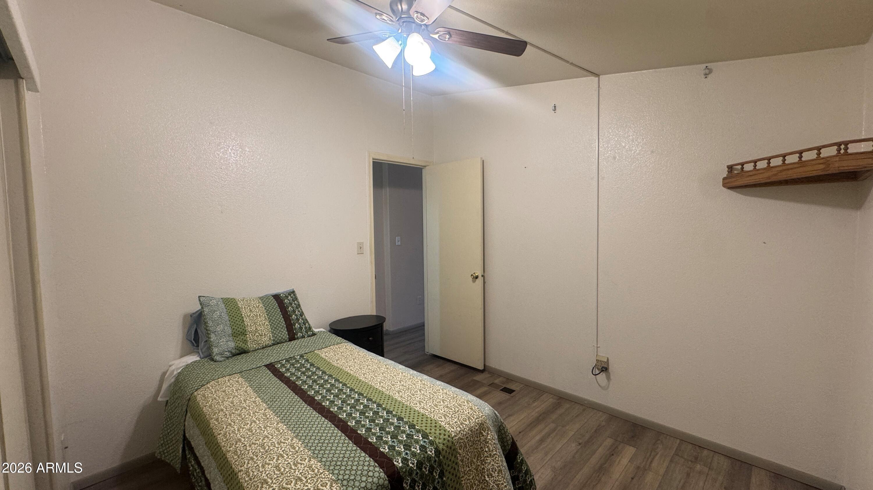 3700 South Tomahawk Road, Unit 95 Apache Junction, AZ 85119 - Photo 17 of 31 a bedroom with a bed and a ceiling fan