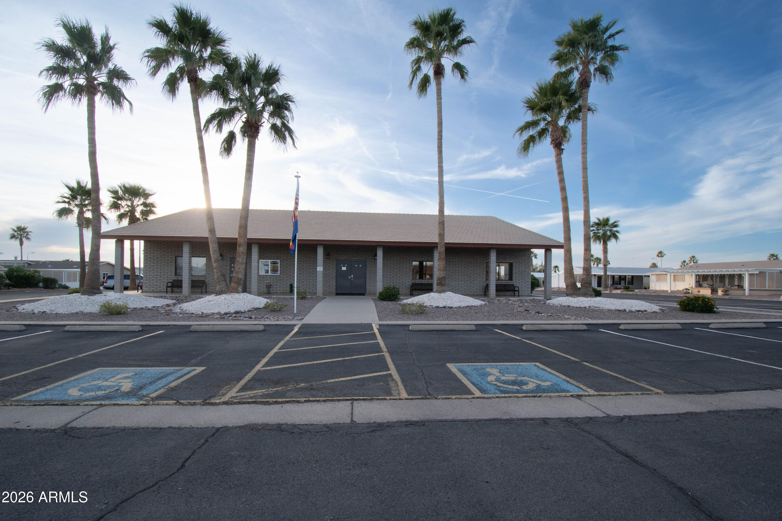 3700 South Tomahawk Road, Unit 95 Apache Junction, AZ 85119 - Photo 26 of 31 a view of a house with a yard and palm trees