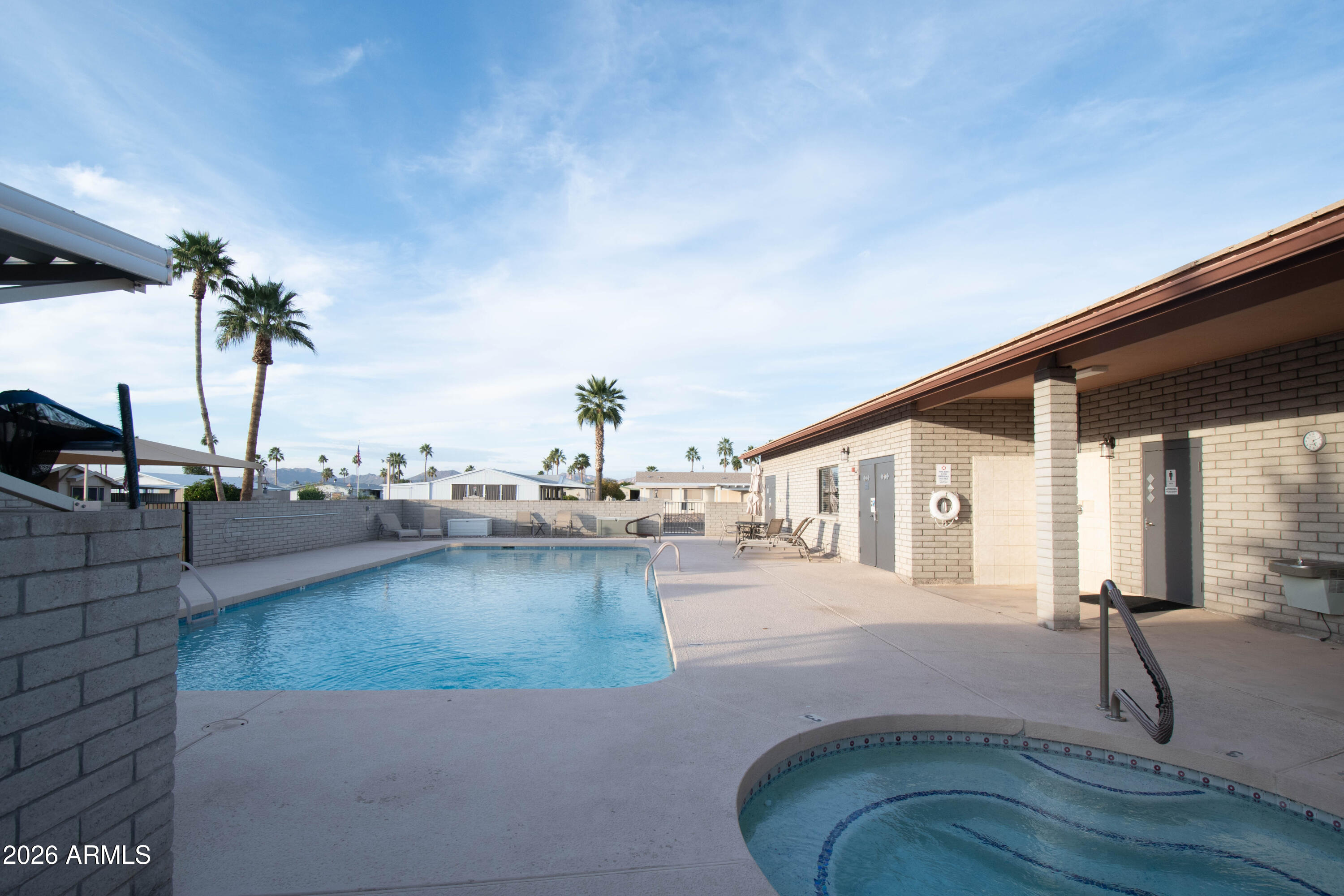 3700 South Tomahawk Road, Unit 95 Apache Junction, AZ 85119 - Photo 27 of 31 a swimming pool with outdoor seating and yard