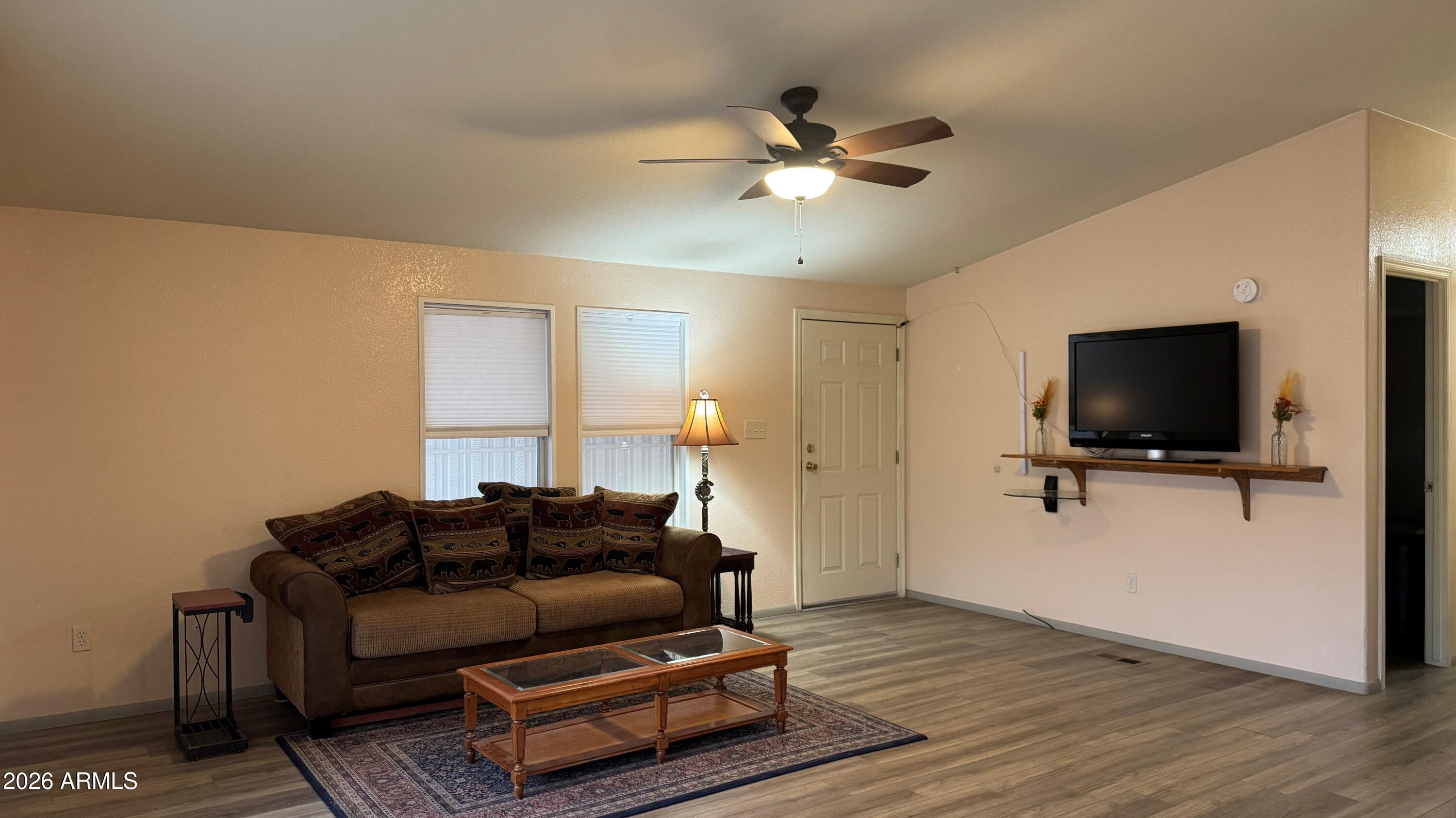 3700 South Tomahawk Road, Unit 95 Apache Junction, AZ 85119 - Photo 4 of 31 a living room with furniture and a flat screen tv