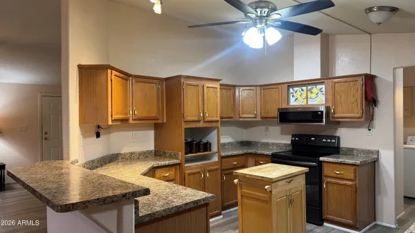 a kitchen with stainless steel appliances granite countertop a stove and a refrigerator