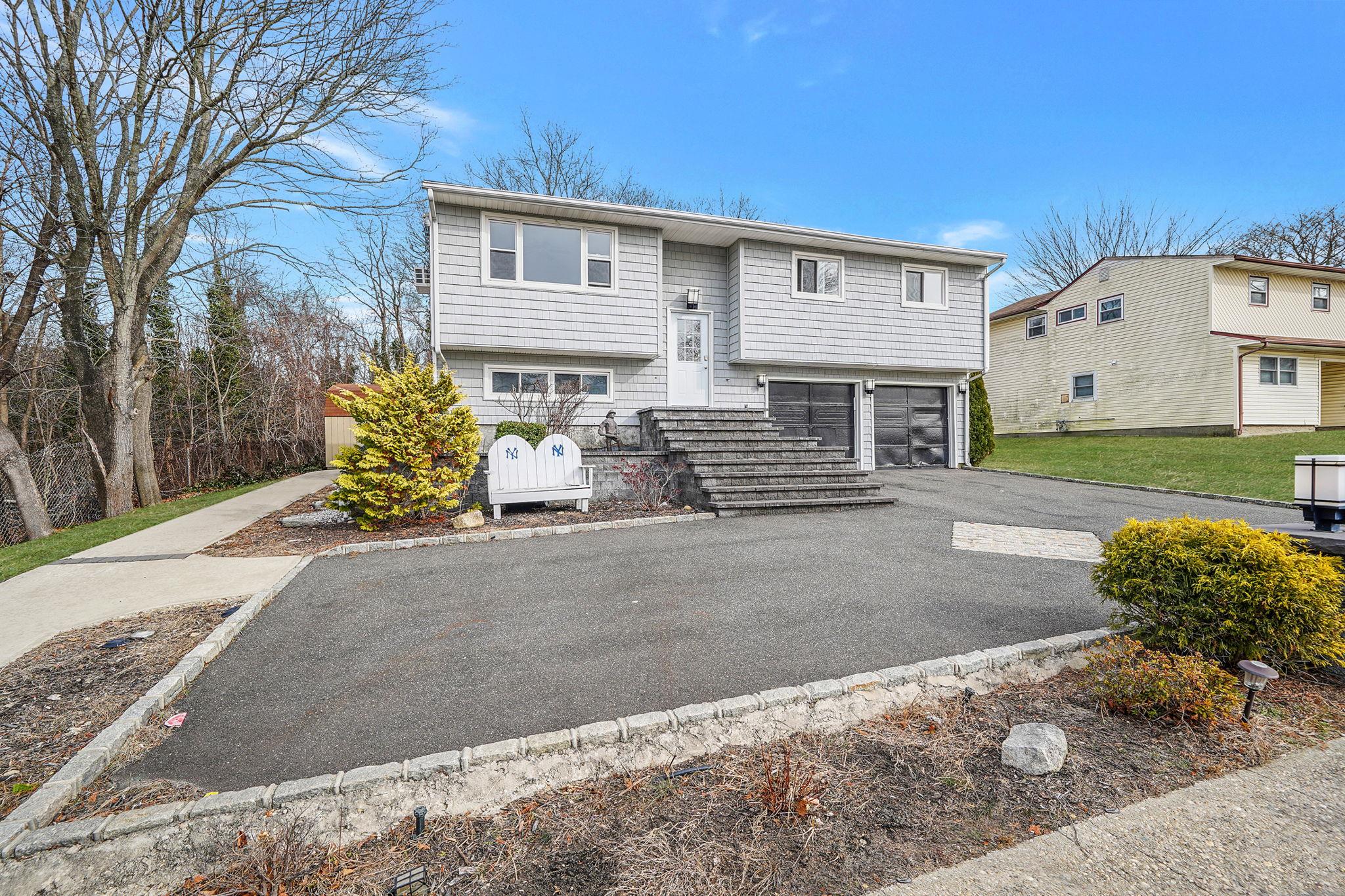 15 Bart Drive Selden, NY 11784 - Photo 1 of 1 Raised ranch featuring a garage and asphalt driveway