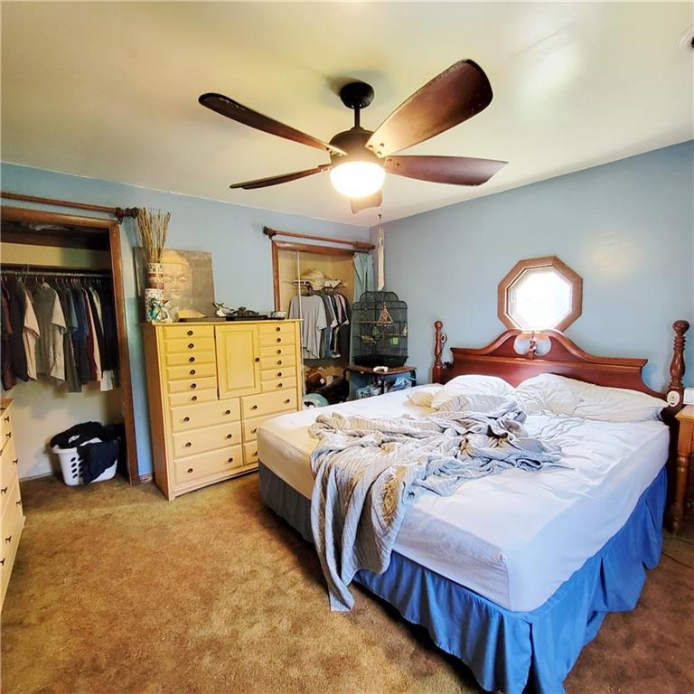 241 Tate Road Hookstown, PA 15050 - Photo 8 of 11 a bedroom with a bed and a chandelier
