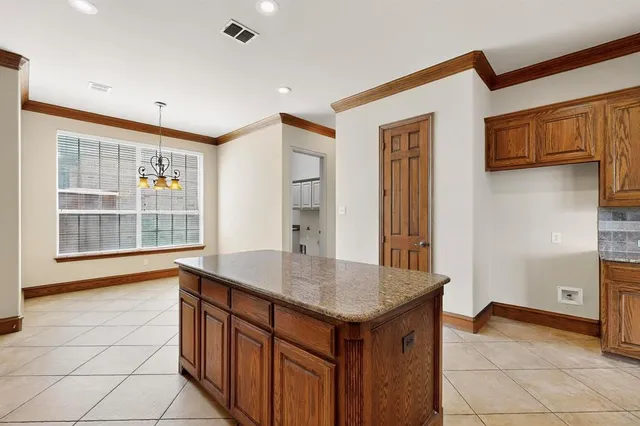 a kitchen with stainless steel appliances granite countertop a stove top oven and refrigerator