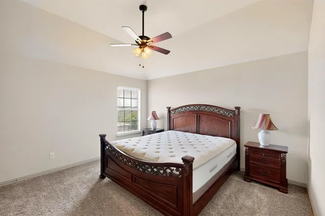 an empty room with windows and ceiling fan