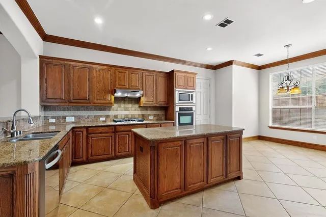 a kitchen with a sink stove and cabinets