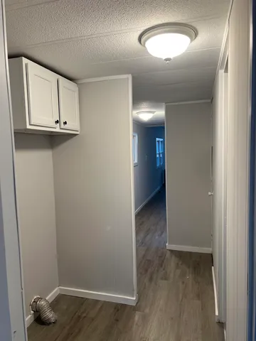 an empty room with wooden floor and closet