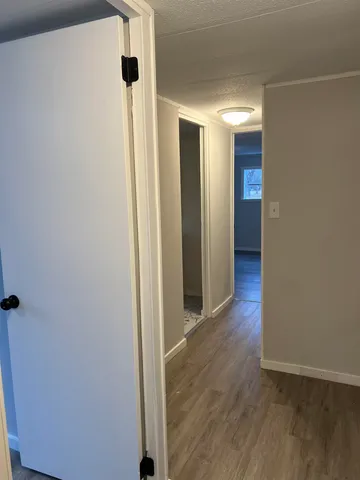 a view of hallway with wooden floor