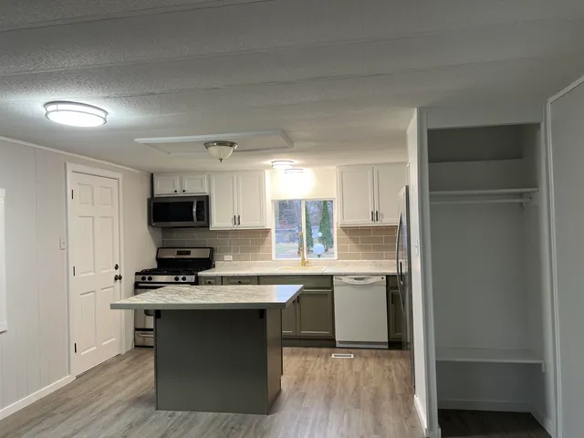 a kitchen with a sink cabinets and stainless steel appliances
