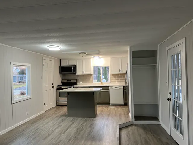 a kitchen with a sink stove and refrigerator
