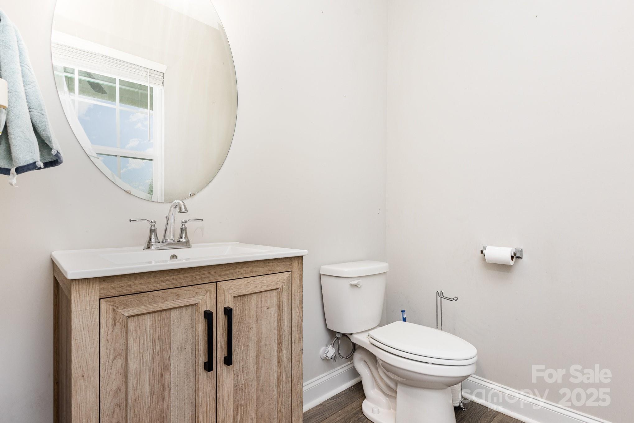 4026 Pigg Mattox Road Monroe, NC 28112 - Photo 14 of 31 a bathroom with a granite countertop toilet a sink and a mirror