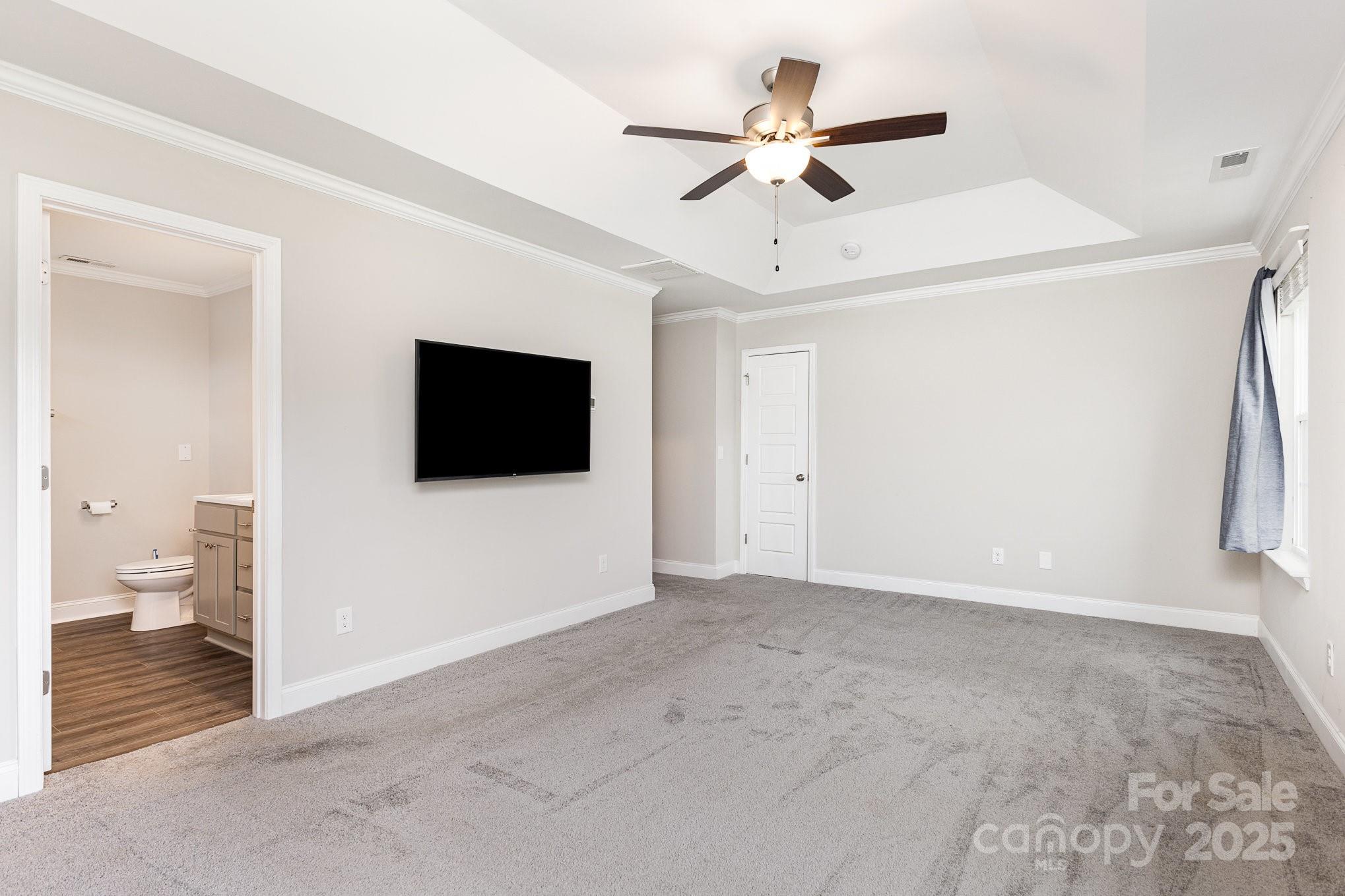 4026 Pigg Mattox Road Monroe, NC 28112 - Photo 18 of 31 a view of a livingroom with an empty space and a ceiling fan