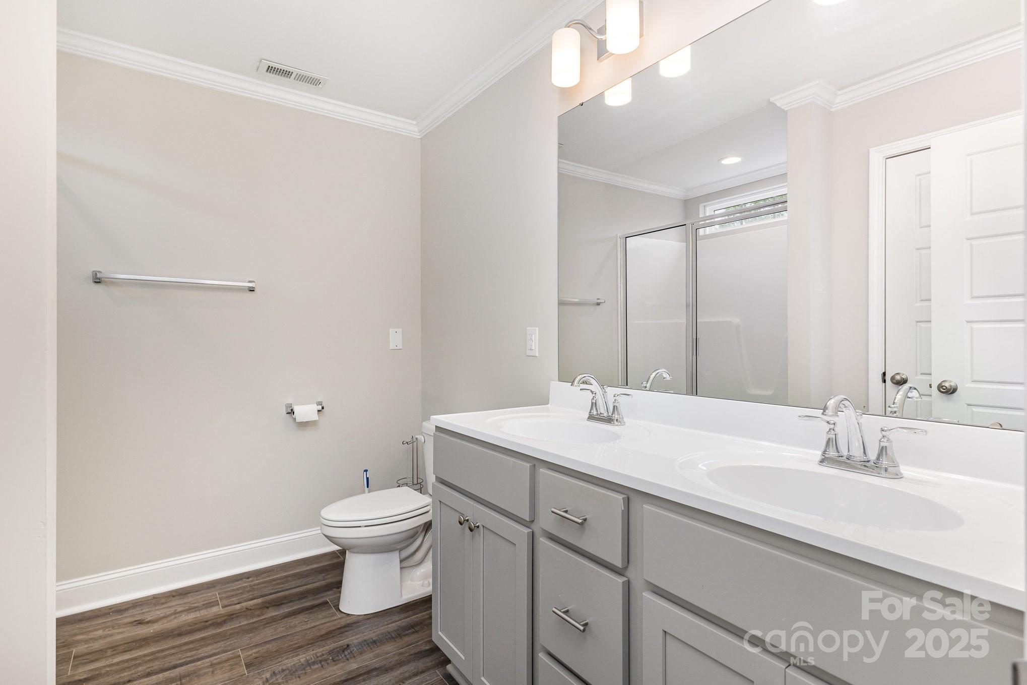 4026 Pigg Mattox Road Monroe, NC 28112 - Photo 27 of 31 a bathroom with a sink a toilet and a large mirror