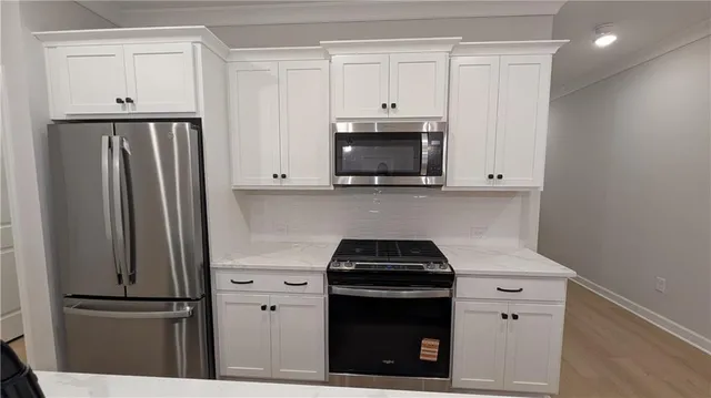 a bathroom with a double vanity sink a toilet and a mirror