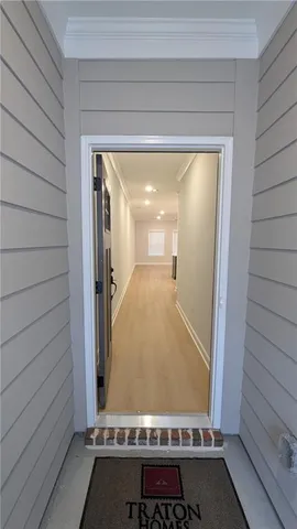 a view with kitchen island a sink wooden floor and living room view