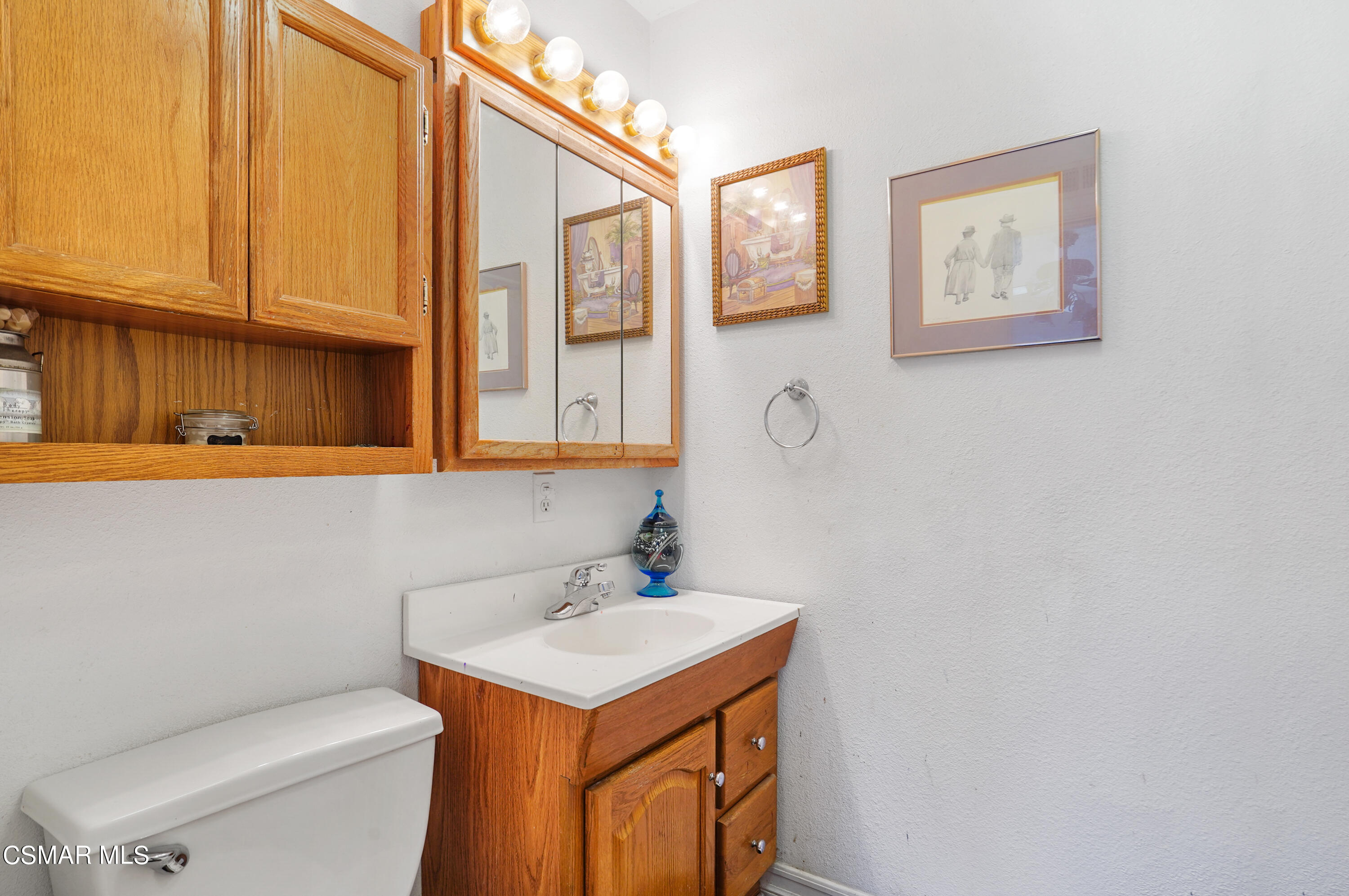 3148 Waco Avenue Simi Valley, CA 93063 - Photo 16 of 24 a bathroom with a sink a toilet and mirror