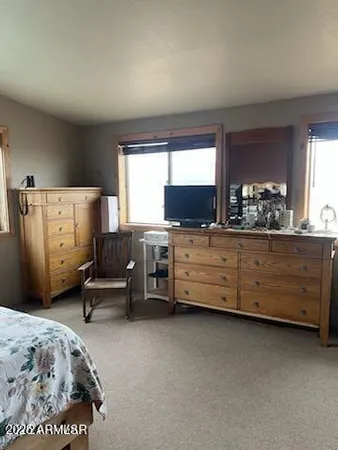 a bedroom with a bed couch and a window