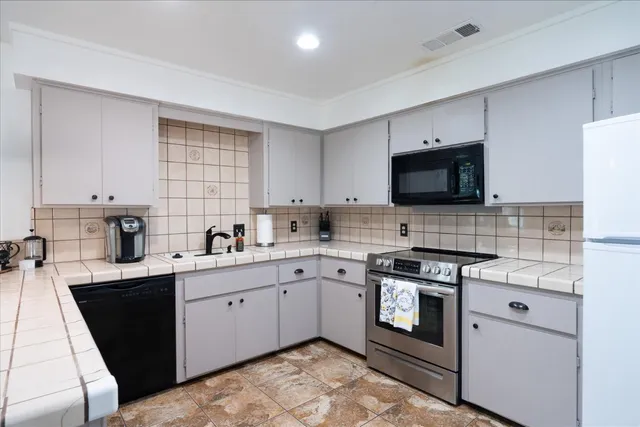 a kitchen with a sink stove and microwave