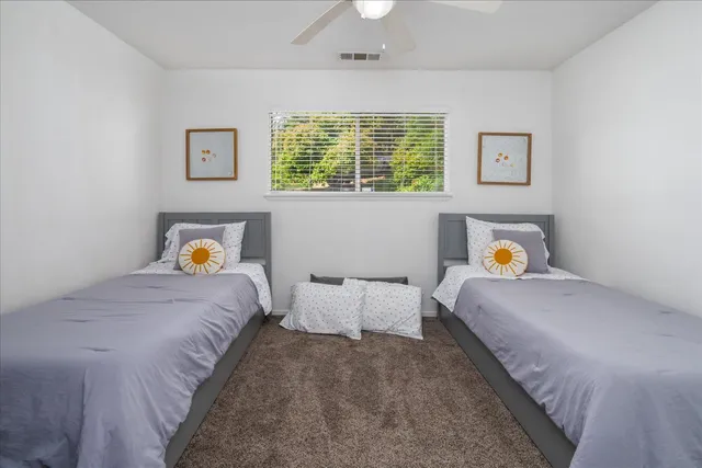 a bedroom with a bed and window