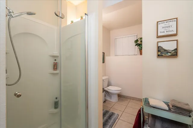 a bathroom with a toilet and a shower