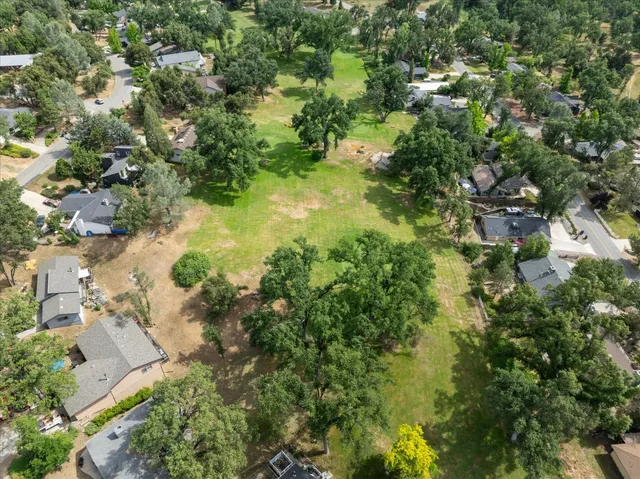 an aerial view of residential houses with yard and swimming pool