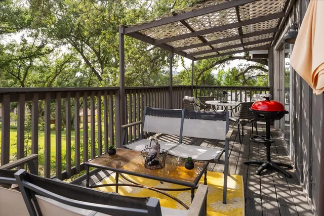 a view of a patio with a table chairs and a potted plant