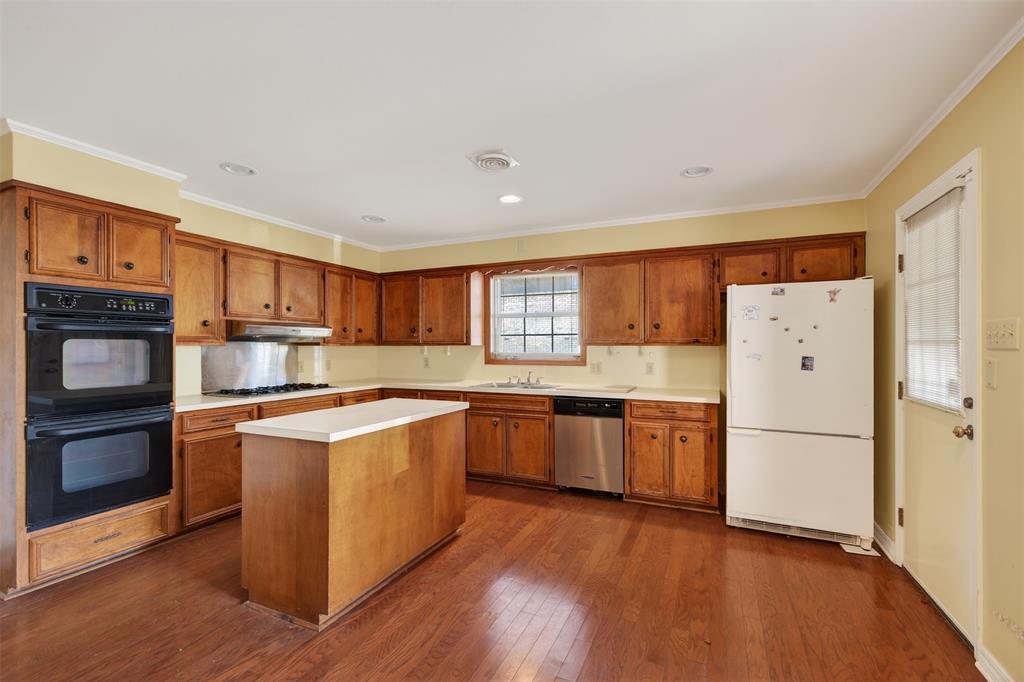 300 Pierremont Road, Unit 25 Shreveport, LA 71106 - Photo 11 of 34 a kitchen with a refrigerator a stove top oven a refrigerator and white cabinets