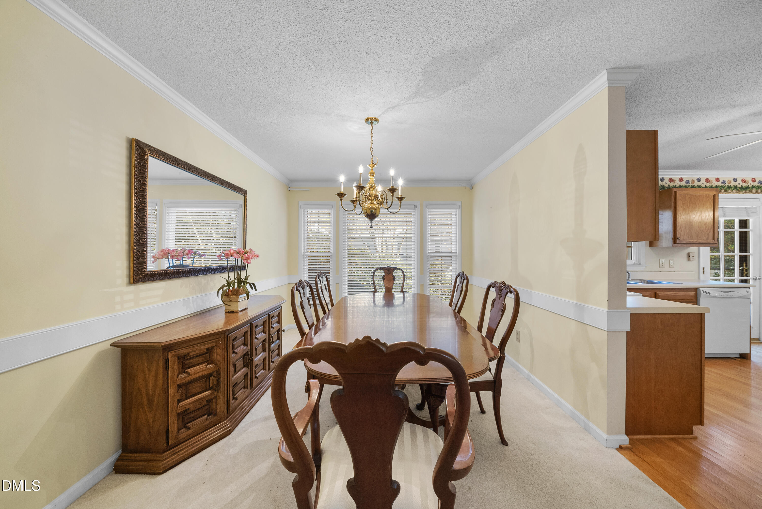 7104 Kinross Drive Raleigh, NC 27613 - Photo 12 of 38 a view of a dining room with furniture and a chandelier