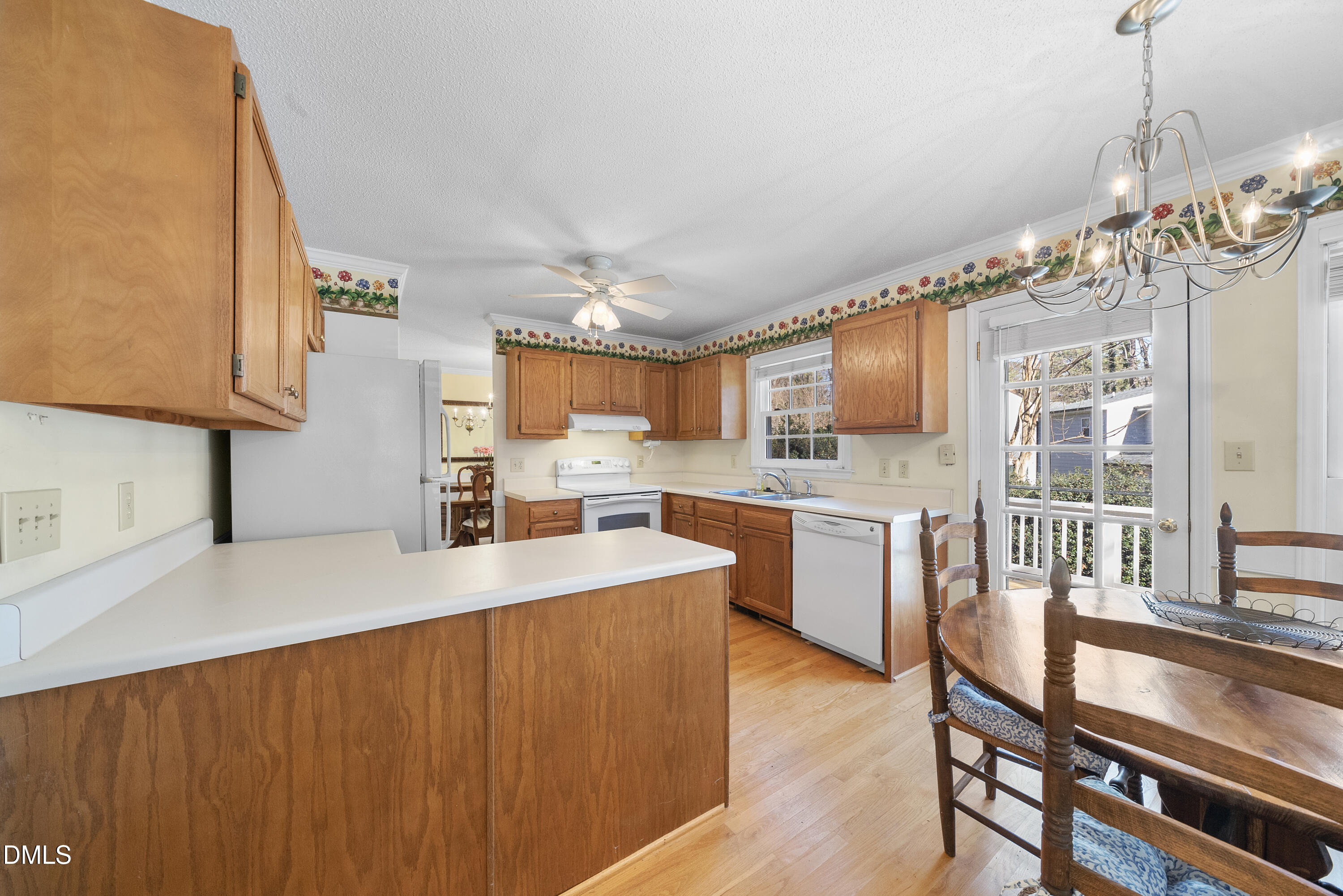 7104 Kinross Drive Raleigh, NC 27613 - Photo 17 of 38 a kitchen with stainless steel appliances granite countertop a sink dishwasher a stove and a refrigerator with wooden floor