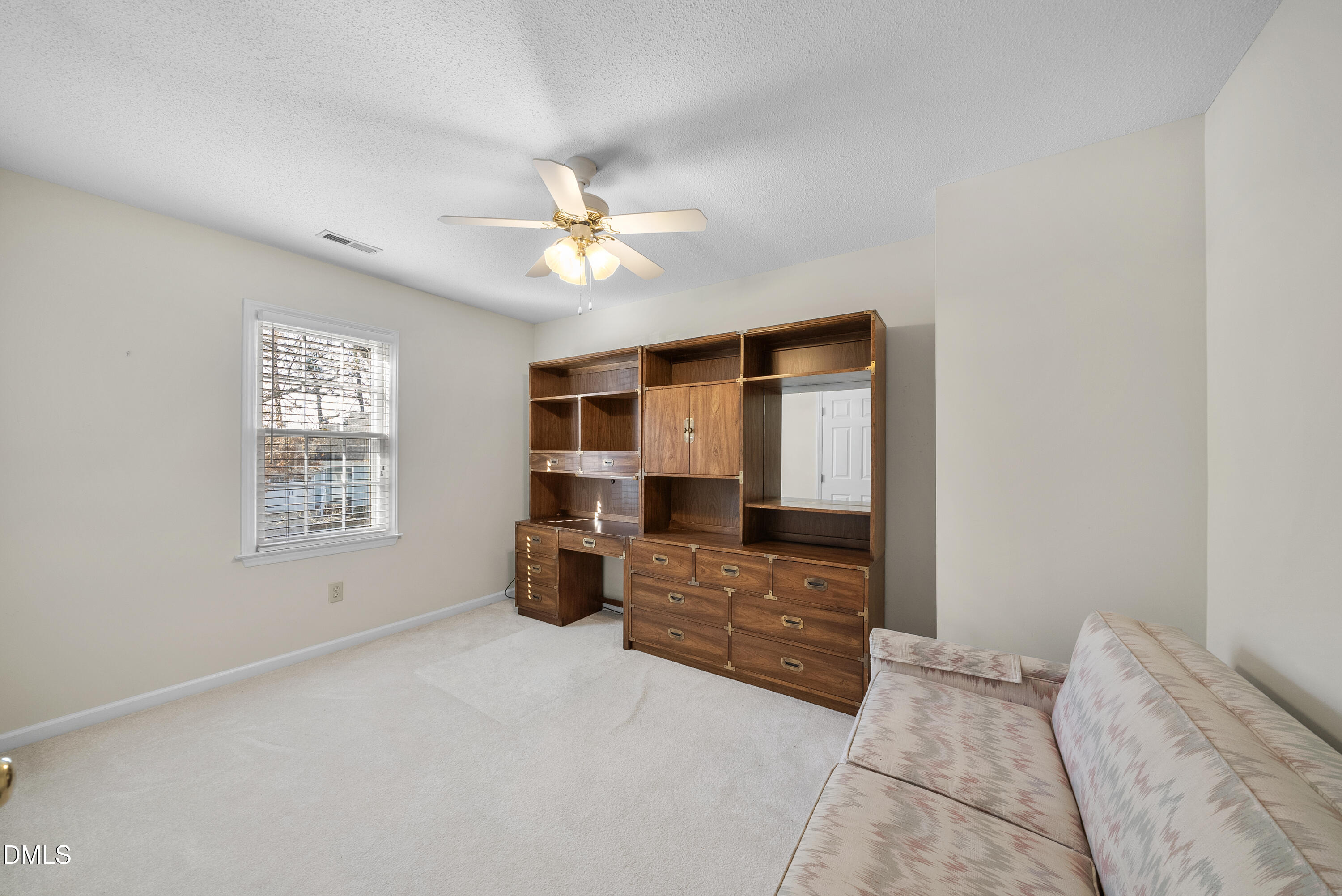 7104 Kinross Drive Raleigh, NC 27613 - Photo 26 of 38 a spacious bedroom with a bed and a chandelier