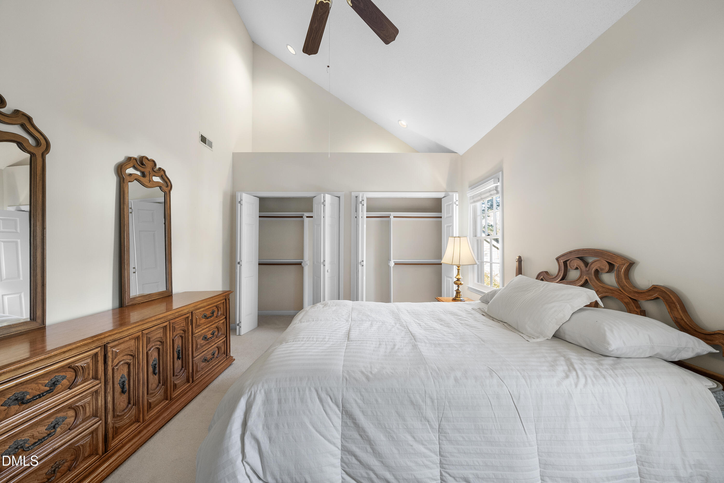 7104 Kinross Drive Raleigh, NC 27613 - Photo 30 of 38 a large bedroom with bed and a large window with wooden floor