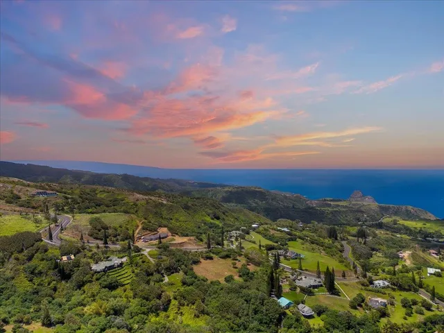 a view of a building in the middle of a yard