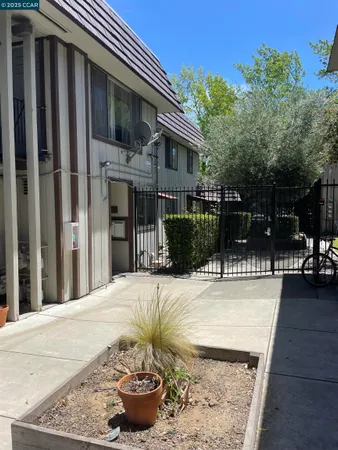a view of a house with backyard and sitting area
