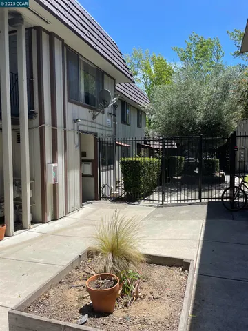 a view of a house with backyard and sitting area