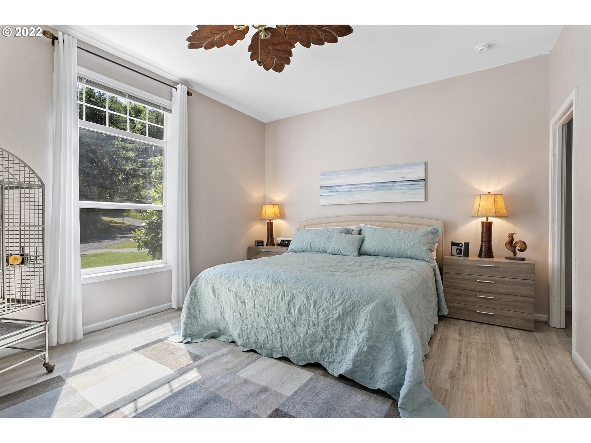 71572 Pruitt Road Rainier, OR 97048 - Photo 17 of 31 a spacious bedroom with a bed and wooden floor