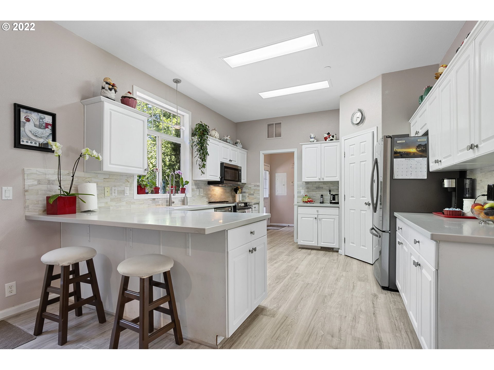 71572 Pruitt Road Rainier, OR 97048 - Photo 7 of 31 a kitchen with white cabinets and stainless steel appliances