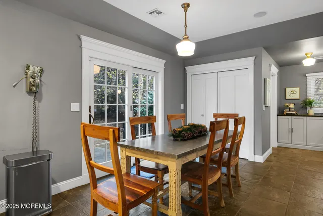 a view of a dining room with furniture and chandelier