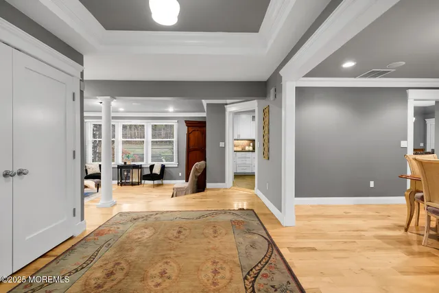 a view of a livingroom with wooden floor and furniture