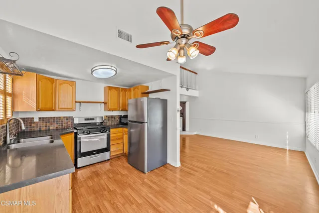 a view of a kitchen with a sink stainless steel appliances and cabinets