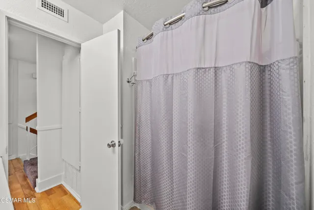 a bathroom with a shower and a tub