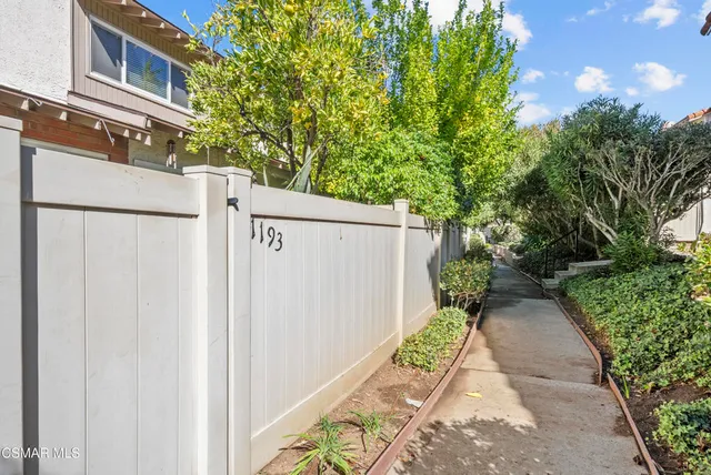 a view of a pathway with a yard