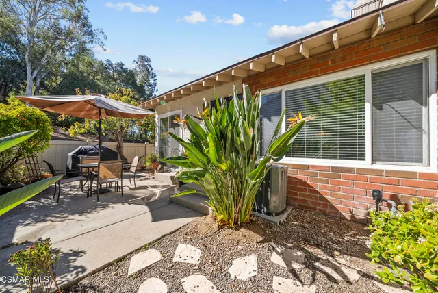 a view of a patio with table and chairs potted plants