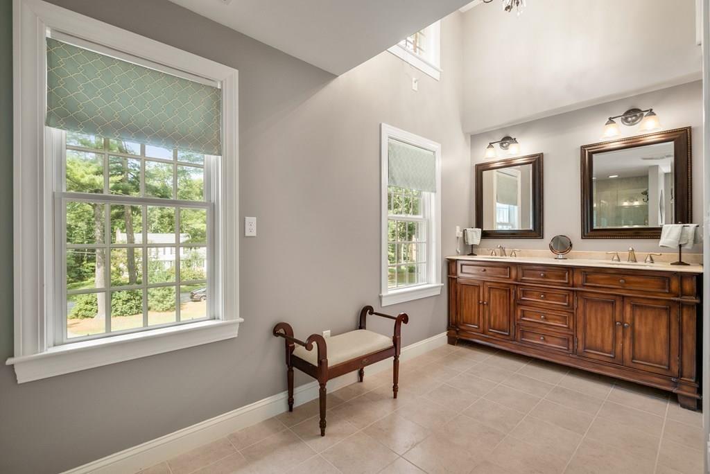34 Wake Robin Road Sudbury, MA 01776 - Photo 15 of 34 a spacious bathroom with a double vanity sink a mirror and a bathtub next to a window