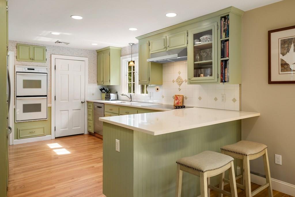 34 Wake Robin Road Sudbury, MA 01776 - Photo 6 of 34 a kitchen with a table chairs sink and cabinets