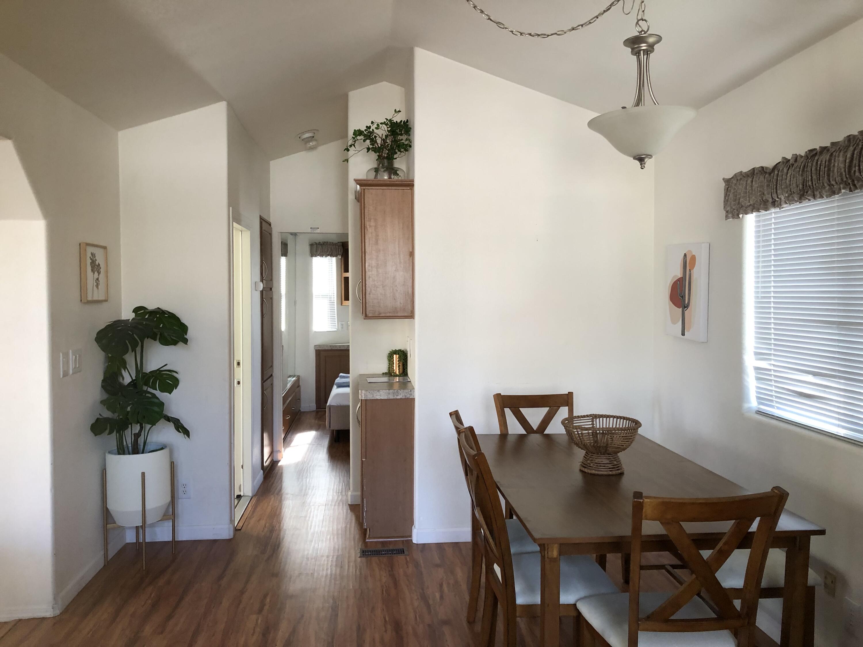 74711 Dillon Road Desert Hot Springs, CA 92241 - Photo 5 of 38 a view of a dining room with furniture window and wooden floor