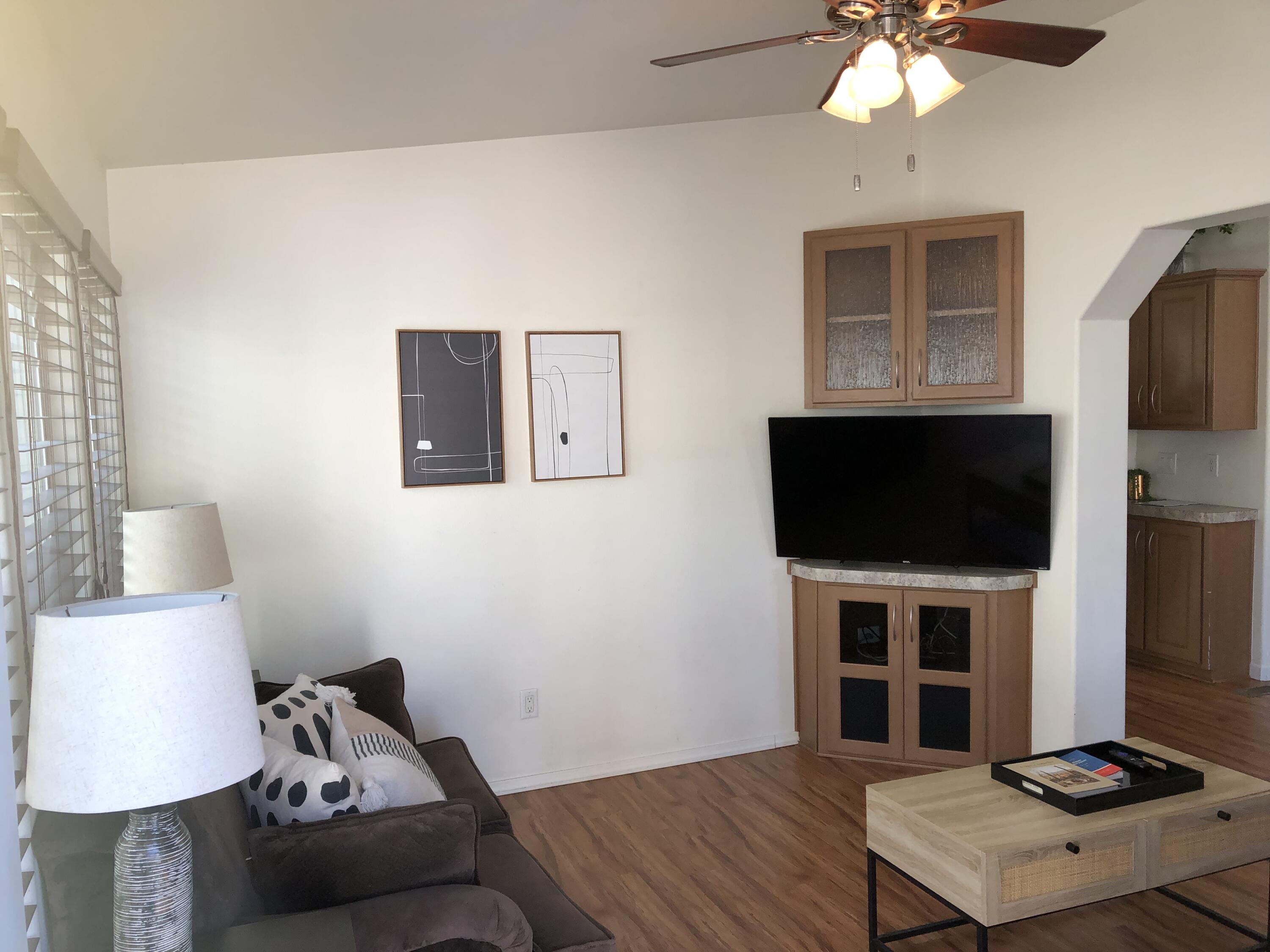 74711 Dillon Road Desert Hot Springs, CA 92241 - Photo 6 of 38 a living room with a flat screen tv and a lamp