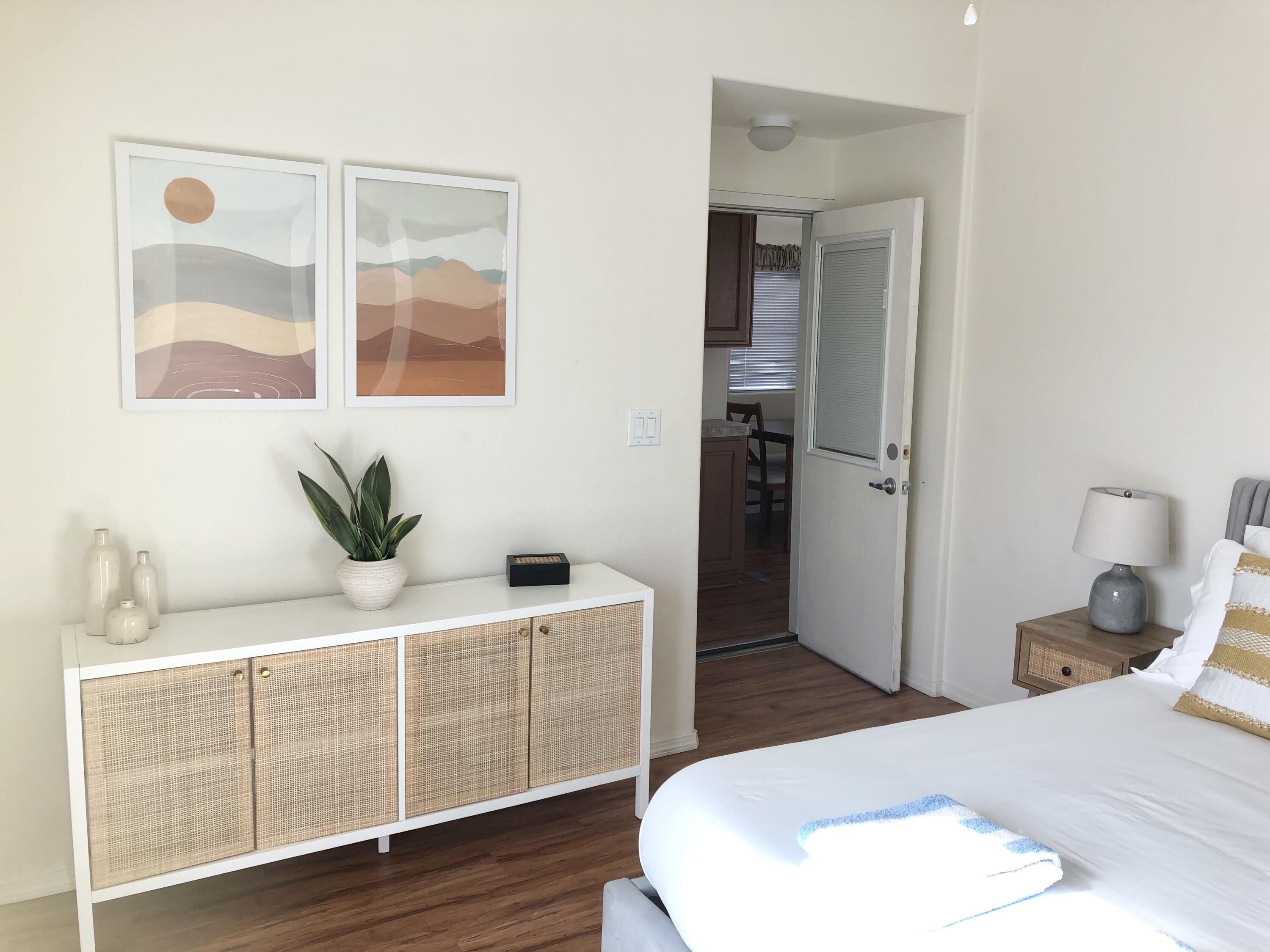 74711 Dillon Road Desert Hot Springs, CA 92241 - Photo 10 of 38 a bedroom with a bed and wooden floor