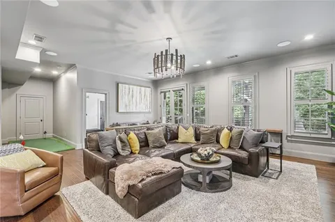a view of a dining room with furniture wooden floor and chandelier