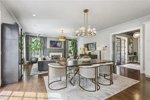 a kitchen with kitchen island a stove a sink a center island and wooden floor
